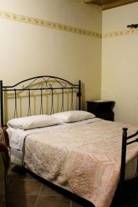 a bedroom with a bed with a metal frame at La Fattoria in Cusano Mutri