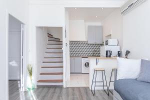 a white apartment with a staircase and a kitchen at La Maison de Famille 3 chambres 8 pers Terrasse Parking Clim in Marseille