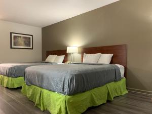 two beds in a hotel room next to each other at Econo Lodge in Troy