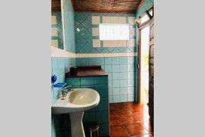 a bathroom with a sink and a mirror and a window at La Casa Flores, maison traditionnelle portugaise in Odeceixe +28 photos