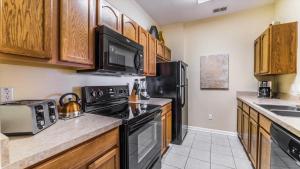 A kitchen or kitchenette at The Ultimate 5 Star Condo on Windsor Hills Resort, Orlando Condo 4782
