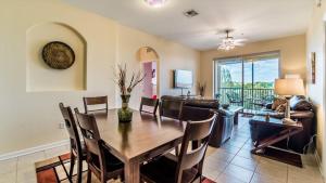 a dining room and living room with a table and chairs at The Ultimate 5 Star Condo on Windsor Hills Resort, Orlando Condo 4782 in Orlando
