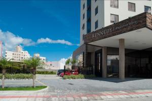 a building with a car parked in front of it at Kennedy Executive Hotel in São José