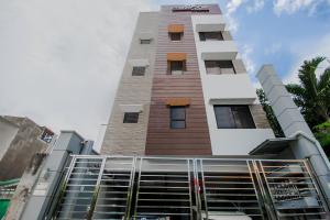a tall building with a sign on top of it at Cornerstone Manor Inn in Cebu City