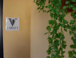a sign on a wall that says carbury next to a plant at B&B Carlo V in Crotone