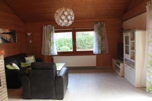 a living room with a couch and a chandelier at Ferienhaus Buchenblick in Ankelohe