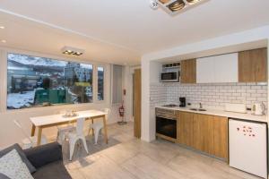 a kitchen and living room with a table and a kitchen and a dining room at Temporales Ushuaia - Bahia loft in Ushuaia
