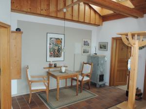 a dining room with a table and chairs and a wood stove at FW Zauberblick in Zwiesel