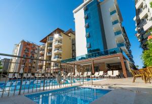 a swimming pool in front of a building at Kleopatra Life Hotel in Alanya