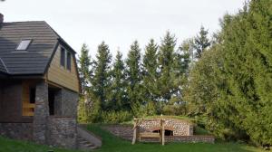 a house with a bench in front of a yard at Lawendowe Siedlisko in Suwałki