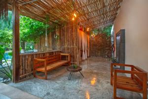 a pavilion with a bench and a table at Tierra Maya Hotel Spa & Sanctuary in Bacalar
