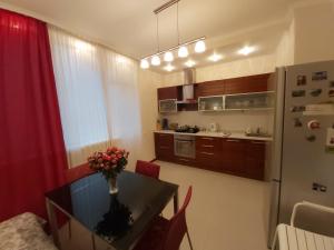 a small kitchen with a table and a refrigerator at Lux Apartment, Liko Grad in Kyiv