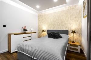 Posteľ alebo postele v izbe v ubytovaní Apartament Zacisze z prywatną sauną