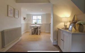 a hallway with a table and a dining room at Carlton Cottage, Castleton in Castleton