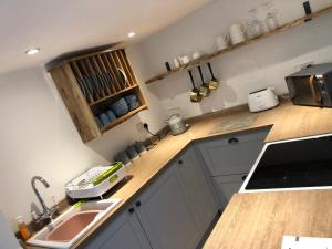 a kitchen with a sink and a counter top at Carlton Cottage, Castleton in Castleton