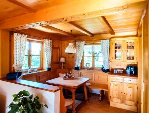 a kitchen with a table and some windows at Ferienwohnung Reisenauer in Marquartstein