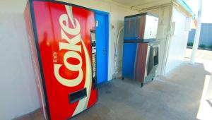 a coke cola vending machine next to a television at Magnuson Hotel Sierra Vista in Sierra Vista