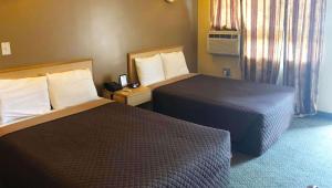 Postel nebo postele na pokoji v ubytování M Star Hotel Mansfield