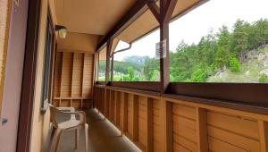 a balcony with a chair and a window at Magnuson Grand Rushmore View in Keystone