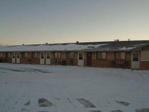 a building with snow on top of it at Arrowhead Inn New Salem in New Salem