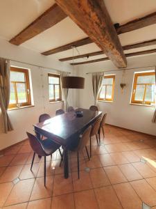 a dining room with a wooden table and chairs at Ferienhaus Schmitt in Beltheim
