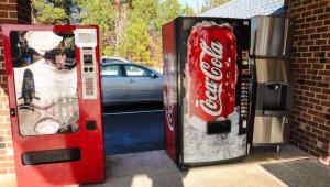 a cocacola machine and a vending machine with a car at Budget Inn Franklinton in Franklinton