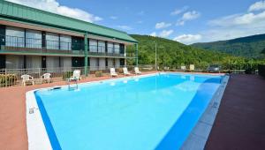 a large swimming pool in front of a hotel at Magnuson Hotel Mountain View in Covington