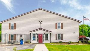 a large white church with a red door at Royal Inn Rockville in Rockville