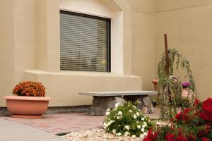 a bench sitting in front of a building with flowers at Mountain Home Inn in Mountain Home