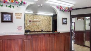 a waiting room with a reception counter in a building at Magnuson Hotel Bradenton in Bradenton +39 photos