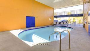 a large swimming pool in a building at Magnuson Hotel Bradenton in Bradenton