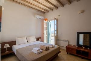 A bed or beds in a room at Natural Stone Villas
