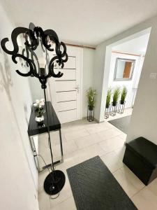 a hallway with a large black chandelier in a house at Willa Mała Beskidzka in Wisła