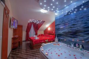 a bedroom with a bed and a tub in it at Villa Dislievski in Ohrid