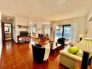 a living room with a couch and a table at Villa Pilar in Playa Blanca