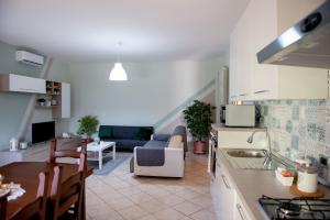 cocina y sala de estar con sofá y mesa en IL NIDO DEI NONNI -Casa Vacanze, en Paglieta