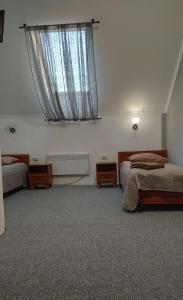 a bedroom with two beds and a window at Bra Haus in Branev