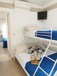 a bedroom with a bunk bed with blue and white at Hotel Bellini in Riccione