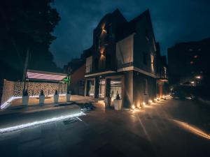 a building with lights on a street at night at Kameralny in Zielona Góra