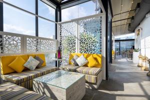 a lobby with couches and a glass table at Crowne Plaza Doha - The Business Park by IHG in Doha