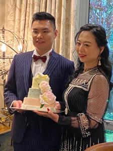 a man and a woman holding a wedding cake at Silverstream Lodge in Lincoln