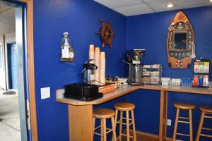 a blue room with a bar with stools in it at Lighthouse Cove Inn in Bandon