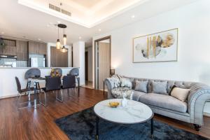 a living room with a couch and a table at Live in the middle of Lagoons and Sea in Ras al Khaimah