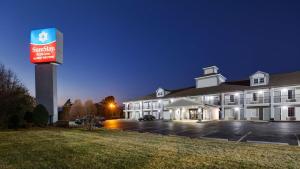 a large building with a sign in a parking lot at SureStay Plus Hotel by Best Western Asheboro in Asheboro