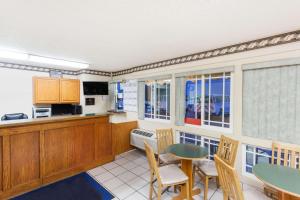 a kitchen and dining room with a table and chairs at Days Inn by Wyndham Barstow in Barstow