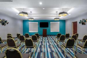 a conference room with chairs and a tv at La Quinta by Wyndham Tampa Central in Tampa