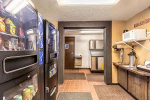 a kitchen with a refrigerator and a door to a room at Value Inn Kenosha I-94 - Exit 344 in Pleasant Prairie