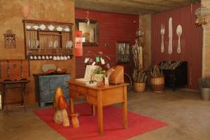 a room with a table and a kitchen with utensils at Molí del Casó B&B in Bagá