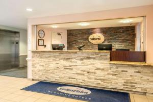 a lobby of a dental office with a reception counter at Suburban Studios Near Camp Lejeune in Jacksonville