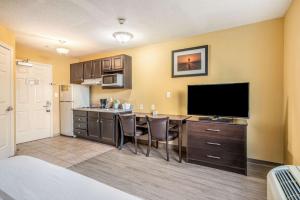 a room with a kitchen with a desk and a television at Suburban Studios Near Camp Lejeune in Jacksonville